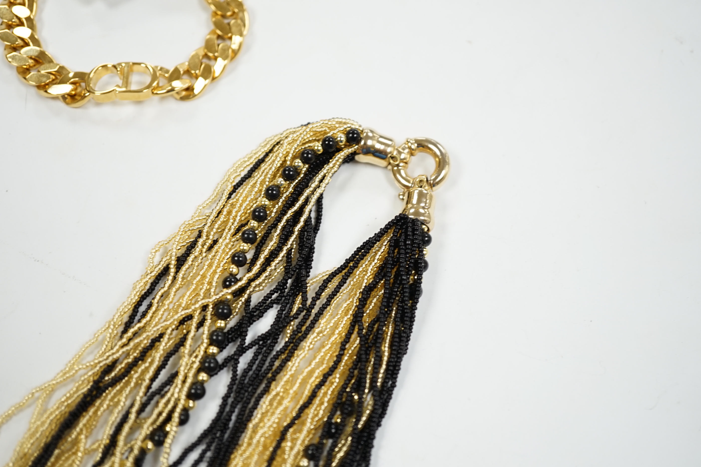 A Christian Dior Danseuse Etoile gilt bracelet, 18cm, with Dior box and pamphlet etc. together with a Luciani Murano glass bead twist necklace, 48cm.